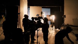 Film crew working in a studio setup.